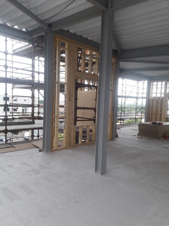 Interior of the building under construction with exposed steel columns